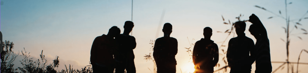 Young people enjoying a sunset outdoors.